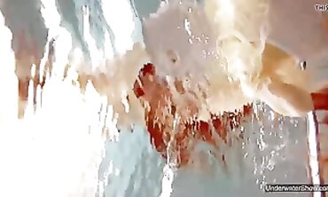 Two Cute Babes Enjoy a Nude Swim in the Pool