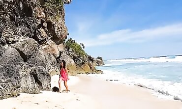 Solo Female Pees on Tropical Beach Rock