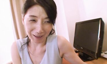 Accomplished Japanese with lengthy dark-hued hair Chiduru Tamiya humps with a young boy three