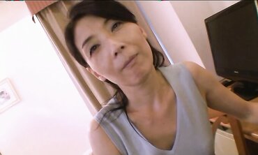 Accomplished Japanese with lengthy dark-hued hair Chiduru Tamiya humps with a young boy three