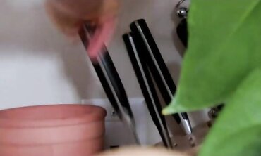 Towheaded streaked dark haired in kitchen, strokes in bury with frigs, mitt-restricted fawcet and a chef's knife. two