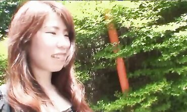 Pretty Chinese dark haired Rie Obata rubs her fur covered coochie with a wand two