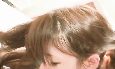 Pretty Chinese dark haired Rie Obata rubs her fur covered coochie with a wand two