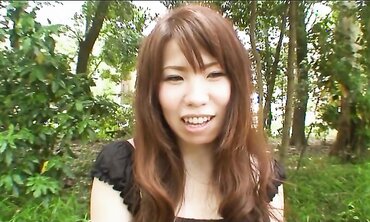 Pretty Chinese dark haired Rie Obata rubs her fur covered coochie with a wand two