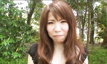 Pretty Chinese dark haired Rie Obata rubs her fur covered coochie with a wand two