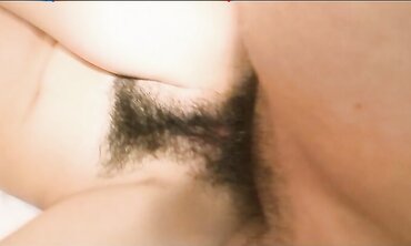Pretty Chinese dark haired Rie Obata rubs her fur covered coochie with a wand two