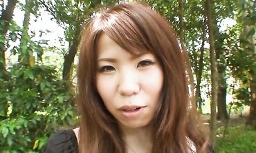 Pretty Chinese dark haired Rie Obata rubs her fur covered coochie with a wand two