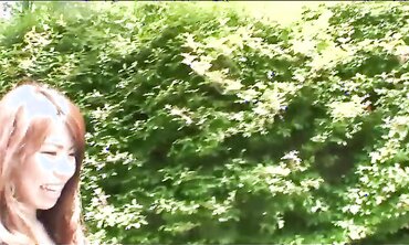 Pretty Japanese black-haired Rie Obata caresses her furry muff with a vibro two