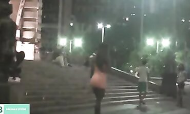 Dark-Haired Latina Flashing in City Traffic