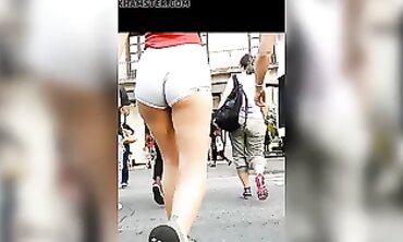 Tanned Babe Shows Off Cheeky Booty in Brief Cut-Offs