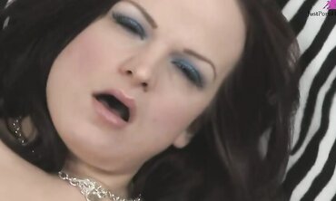Slutty brunette in short tight purple dress masturbates hard on zebra print couch with fingers and vibrators.