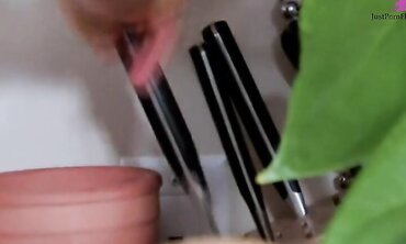 Blonde streaked brunette in kitchen, masturbates in sink with fingers, hand-held fawcet and a chef's knife.