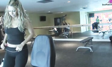 Girl with big tits goes to gym and gets helped with workout.  Repays the trainer with a blowjob by the weights and takes cum shot on her tits.
