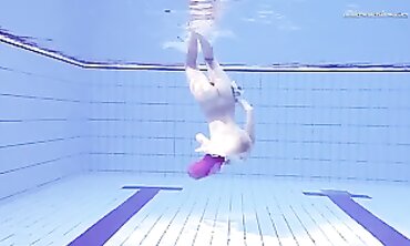 Elena Proklova Swims Nude in Bikini