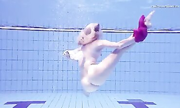 Elena Proklova Swims Nude in Bikini