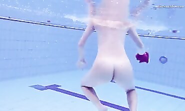 Elena Proklova Swims Nude in Bikini