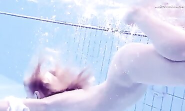 Elena Proklova Swims Nude in Bikini