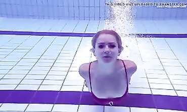 Elena Proklova Swims Nude in Bikini
