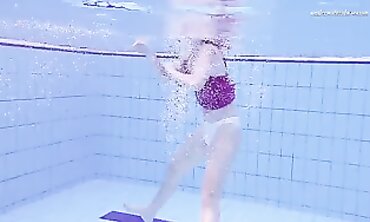 Elena Proklova Swims Nude in Bikini