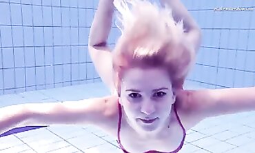 Elena Proklova Swims Nude in Bikini