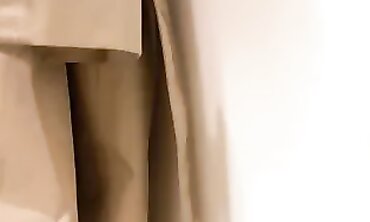 Blonde in Trench Coat Plays with Vibrators