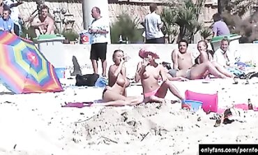 Secret camera while femmes sunbathing bare on the beach