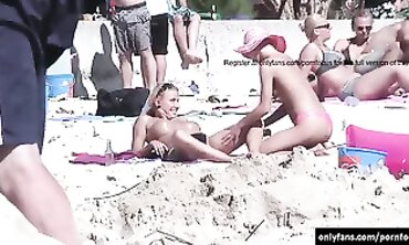 Secret camera while femmes sunbathing bare on the beach
